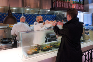 Yale President Peter Salovey serves lunch to a student in Commons.