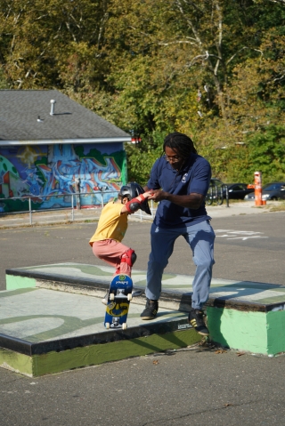 Dr. Neftalie Williams coaches a young skater