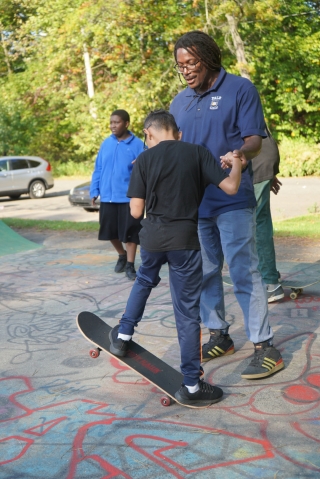 Dr. Neftalie Williams coaches a young skater