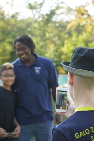 A dad photographs his son with Dr. Neftalie Williams