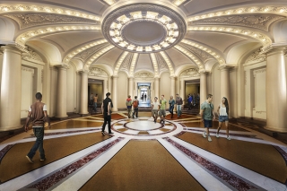 Students walking through the rotunda's warmly-lit interior.