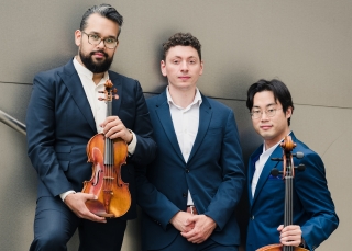 Three musicians in expressive pose, with their instruments