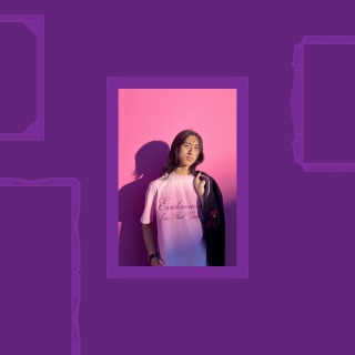 WilliamZhang in a pink t-shirt on a pink wall with shadow, holding a jacket.