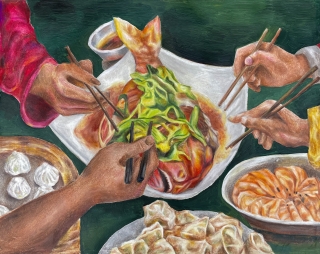 A photo of hands reaching into a shared family dinner with chopsticks